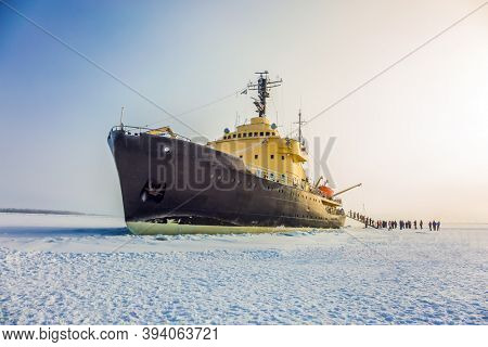 Great icebreaker. Dim winter morning in Lapland. Excursion to the Arctic sea icebreaker. The concept of active and extreme tourism