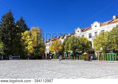 Razlog, Bulgaria - October 20, 2020: Downtown Street Square Panoramic View With Autumn Trees And Peo