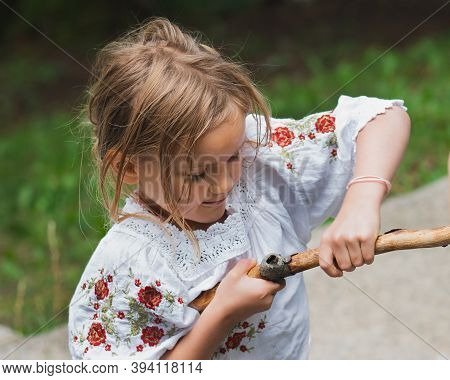 Resourceful Dexterous Little Girl Werking With A Stick.fun Summertime, Provincial Life.