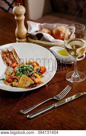 Fresh Salad Plate With Shrimp, Tomato And Mixed Greens On Wooden Background Close Up. Healthy Food.h