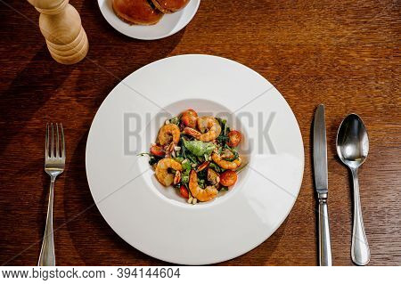 Fresh Salad Plate With Shrimp, Tomato And Mixed Greens On Wooden Background Close Up. Healthy Food.h