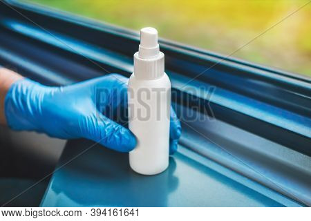 A Man's Hand In A Protective Medical Glove Takes An Antiseptic, Soft Focus