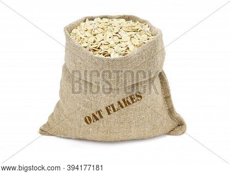 Oat Flakes In A Sack Isolated On A White Background. Oat Flakes In Burlap Sack. Oat Flakes In Jute B