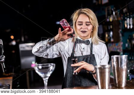 Charming Woman Bartending Mixes A Cocktail At The Nightclub