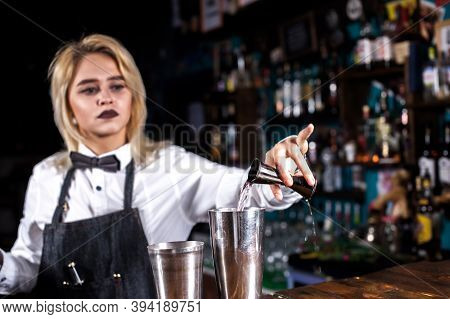 Portrait Of Girl Bartender Makes A Show Creating A Cocktail On The Bar