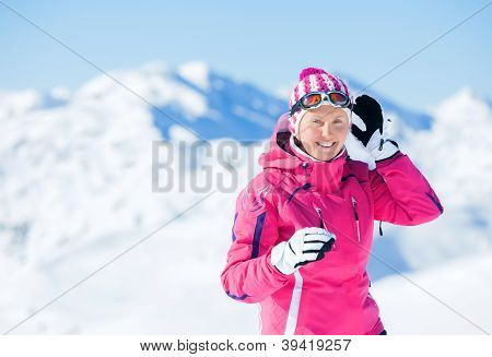 Young woman with skis and a ski wear