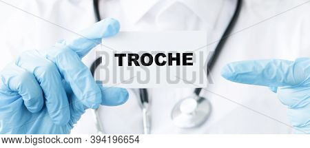 Doctor Holding A Card With Text Troche, Medical Concept