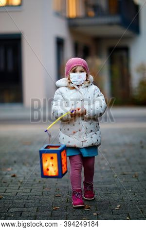 Toddler Girl Holding Selfmade Lantern For St. Martin Procession. Child Wear Medical Mask. Children A