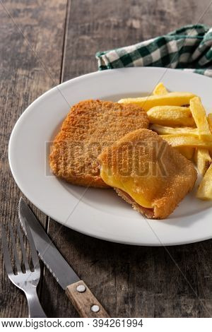 San Jacobo Steak Filled With Cheese And Ham On Wooden Table