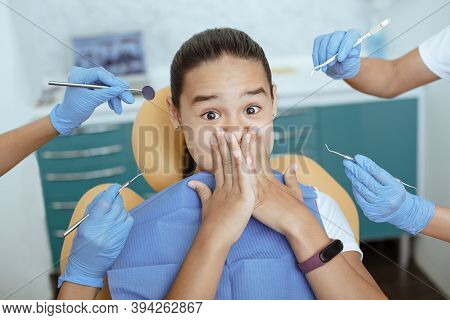 Children Fear, Emotions Of Horror And Treatment Of Oral Cavity In Clinic. Scared Girl With Wide Open