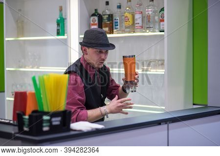 A Experienced Barman Is Preparing And Serving A Colorful Cocktail At The Amper Convention At The Bno