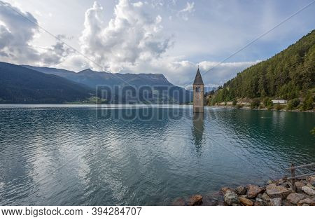 The Bell Tower Of The Sunken Church In Curon, Resia Lake, Bolzano Province, South Tyrol, Italy.
