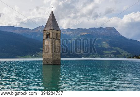 The Bell Tower Of The Sunken Church In Curon, Resia Lake, Bolzano Province, South Tyrol, Italy.
