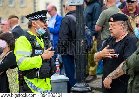 Richmond, North Yorkshire, Uk - June 14, 2020: Police Officer Wearing Face Mask Confronts British An