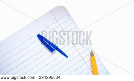 A Yellow Pen With A Blue Open Cap Lying On A Notebook In Line.