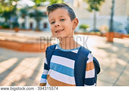 dorable caucasian student boy smiling happy standing at the park.