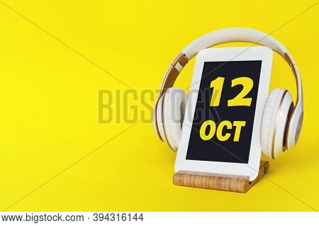 October 12nd. Day 12 Of Month, Calendar Date. Stylish Headphones And Modern Tablet On Yellow Backgro
