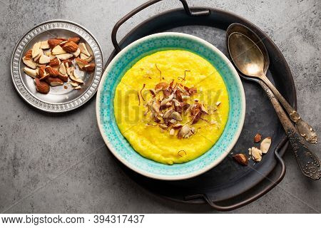 Traditional Indian Dish Kheer, Sweet Rice Milk Pudding With Almonds And Saffron In Blue Ceramic Bowl