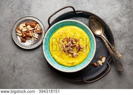 Traditional Indian Dish Kheer, Sweet Rice Milk Pudding With Almonds And Saffron In Blue Ceramic Bowl
