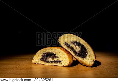 Croissant From Flaky Pastry With Poppy On A White Background