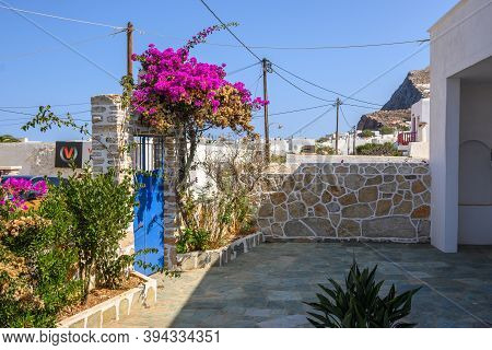 Folegandros, Greece - September 23, 2020: Entrance Gate To Greek House Decorated With Flower On Stre