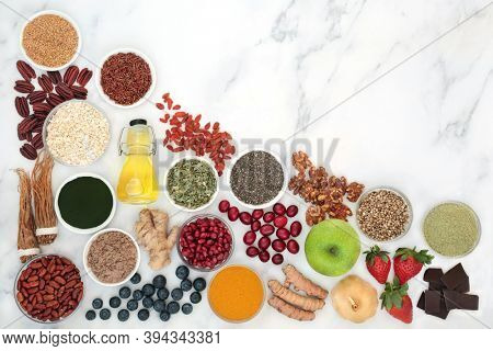 Super food  with herbal medicine for a healthy lifestyle with plant based health foods high in anthocyanins, antioxidants, lycopene, vitamins, minerals, smart carbs, dietary fibre, omega 3 & protein  