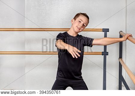Boy To Study Ballet At The Ballet School. The Hand On The Ballet Barre.