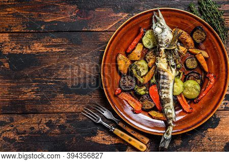 Baked Whole Icefish With Grilled Vegetables. Dark Wooden Background. Top View