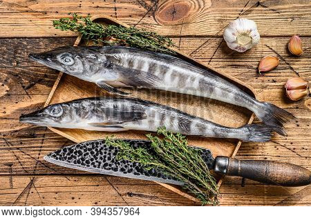 Raw Mackerel Icefish In A Wooden Tray. Wooden Background. Top View
