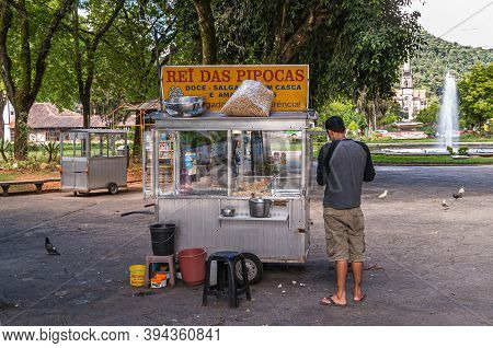Petropolis, Brazil - December 23, 2008: Ambulant Sweet Snack And Popcorn Vendor With Silve Metal Car