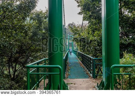 Chilgapsan, South Korea; September 30, 2020: Two Unidentified People On Green Suspension Footbridge 