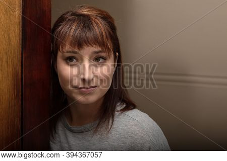 Portrait Of A Woman In Her Thirties Accosted On A Door Frame