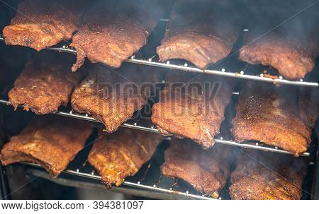 Smoke Rising Around A Slow Cooked Beef Brisket On A Smoker Barbecue Grilling Concept