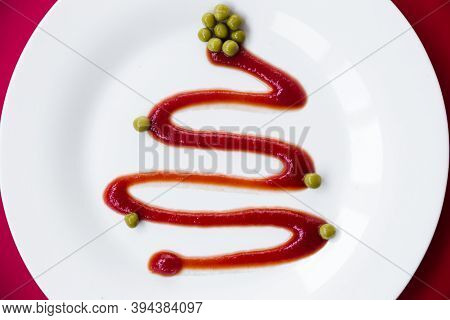 Ketchup In A White Plate Looks Like A Christmas Tree. Green Peas Serve As A Decoration. The Plate St