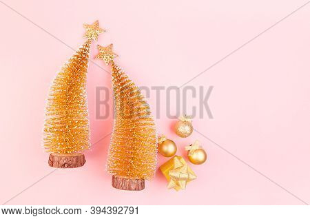 Festive Gentle New Year Background With Glitter Glossy Gold Decorations, Christmas Trees On Pink Bac