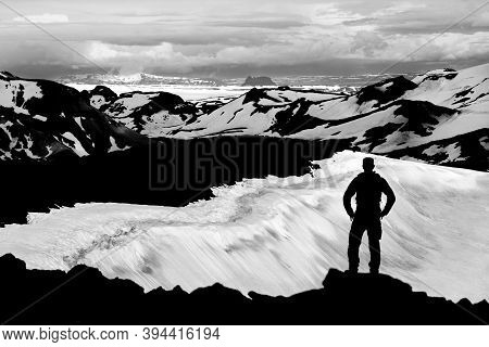 Hiker Man Silhouette Enjoying View From Ok Vulcano Crater To The Snow Mountains Of Thorisdalur. Mono
