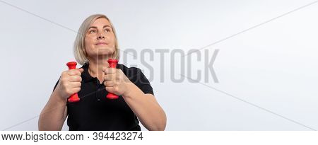 Banner, Long Format. Senior Woman Doing Sports At Home With Dumbbells. Fitness Concept During A Pand