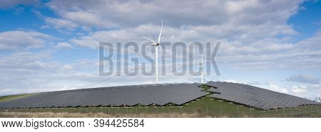 Wind Turbines And Solar Panels Form Alternative Enery Plant In The Netherlands Under Blue Sky With C