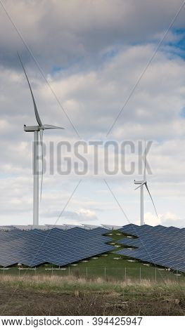 Wind Turbines And Solar Panels Form Alternative Enery Plant In The Netherlands Under Blue Sky With C