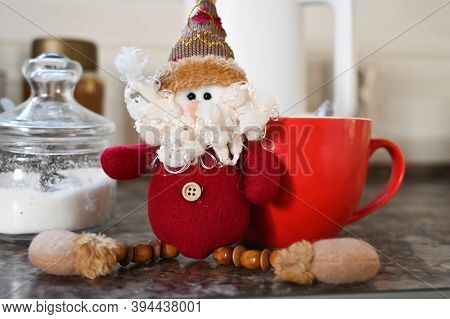 Festive Morning With Christmas Gnom And Big Red Cup Of Coffe On The Background. Holidays At Home Con