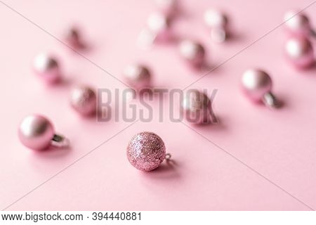 Close Up Of Shiny Christmas Tree Bauble Decorations On Pink Background, Soft Focus.
