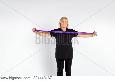 Sporty Senior Woman On White Background With Fitness Elastic Band. Healthy Lifestyle And Pandemic Co