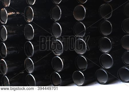 Black Metal Pipes For Gasification Or Water Supply. Industrial Background Close Up