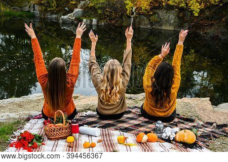 Three Women Best Friends At Autumn Picnic In The Park. Colorful Plaid, Thermos And Pumpins. Friends 