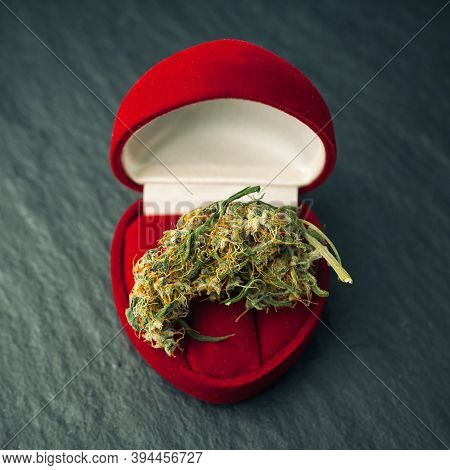 Cannabis Bud In A Ring Box. Concept Of Marriage Proposal And Humorous Marijuana.