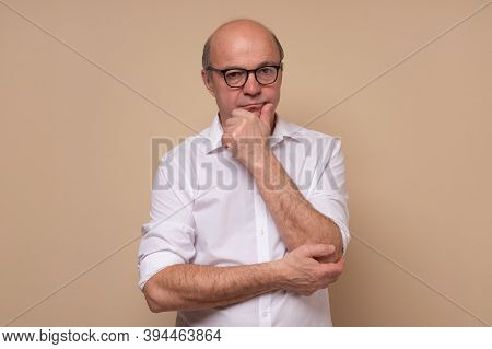 Senior Man Scratching His Chin Making A Hard Decision