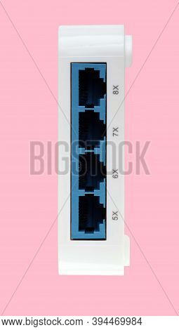 White 8 Port Plastic Ethernet Switch Isolated On Pink Background At Dry Day
