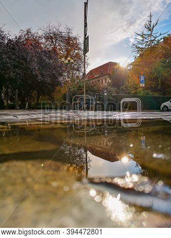 Wroclaw October 10 2019 Bike Parking Park And Buildings Reflected In Puddle
