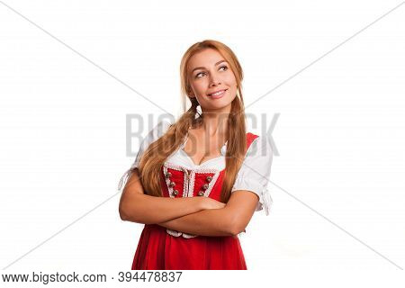 Beautifiul Bavarian Waitress Smiling Joyfully Looking At The Copy Space On The Side Posing Isolated 