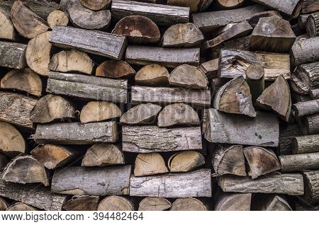 Background Of Splitted, Dried And Stacked Firewood. Bunch Of Wood.